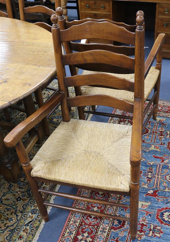 A set of eight ladderback rush seat oak dining chairs